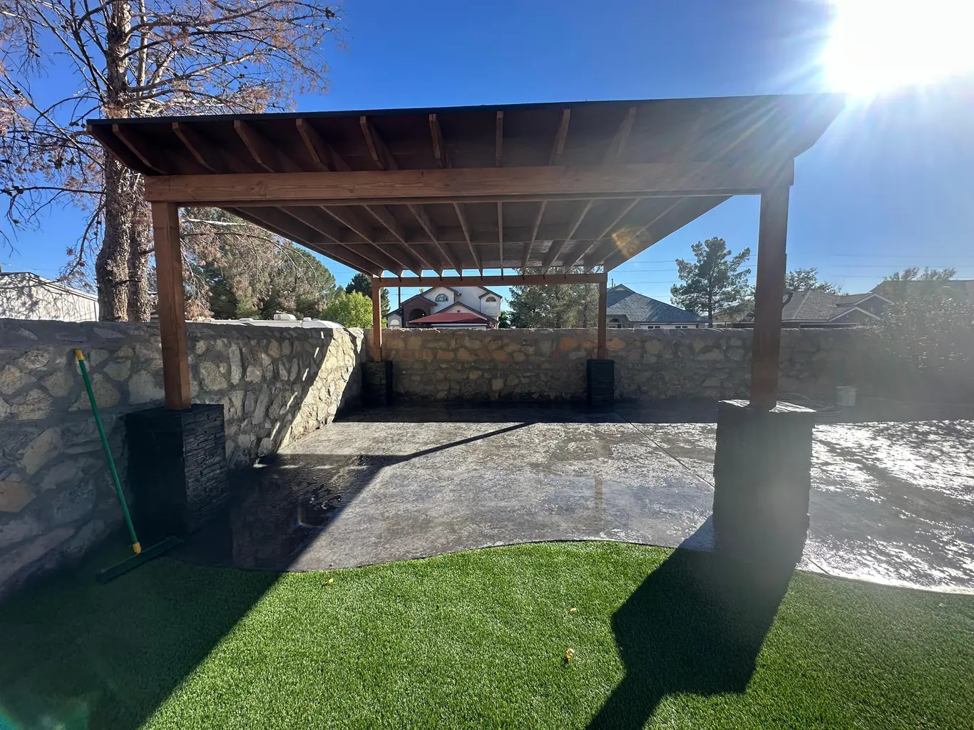 Tall stone retaining wall with custom gate