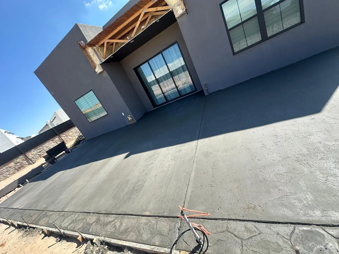 Stamped concrete patio with modern home